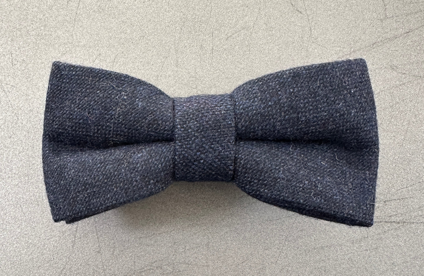 A navy blue wool mens bow tie ideal for weddings and as an accessory to a grooms suit.