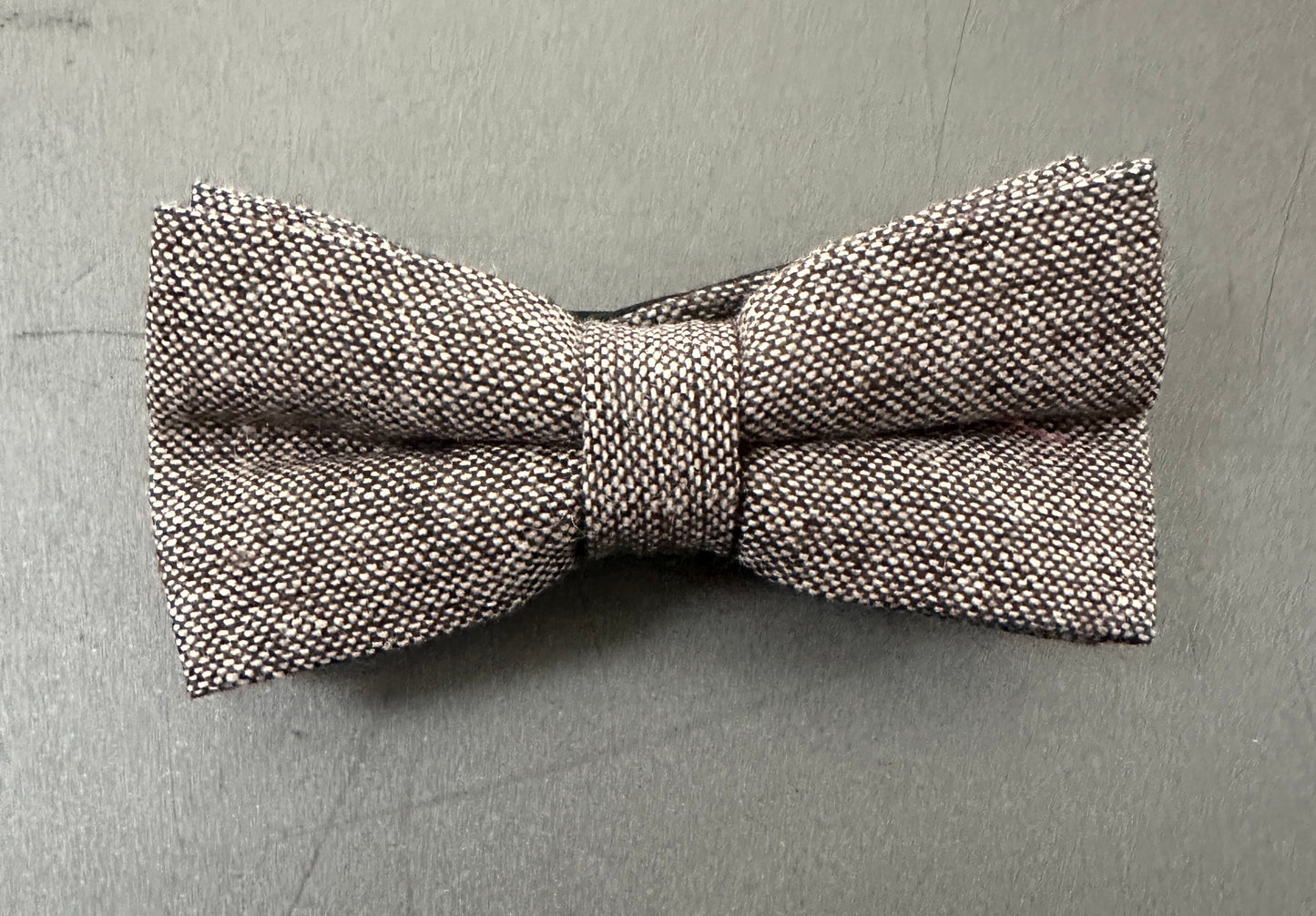 A brown pre tied bow tie in flecked wool.