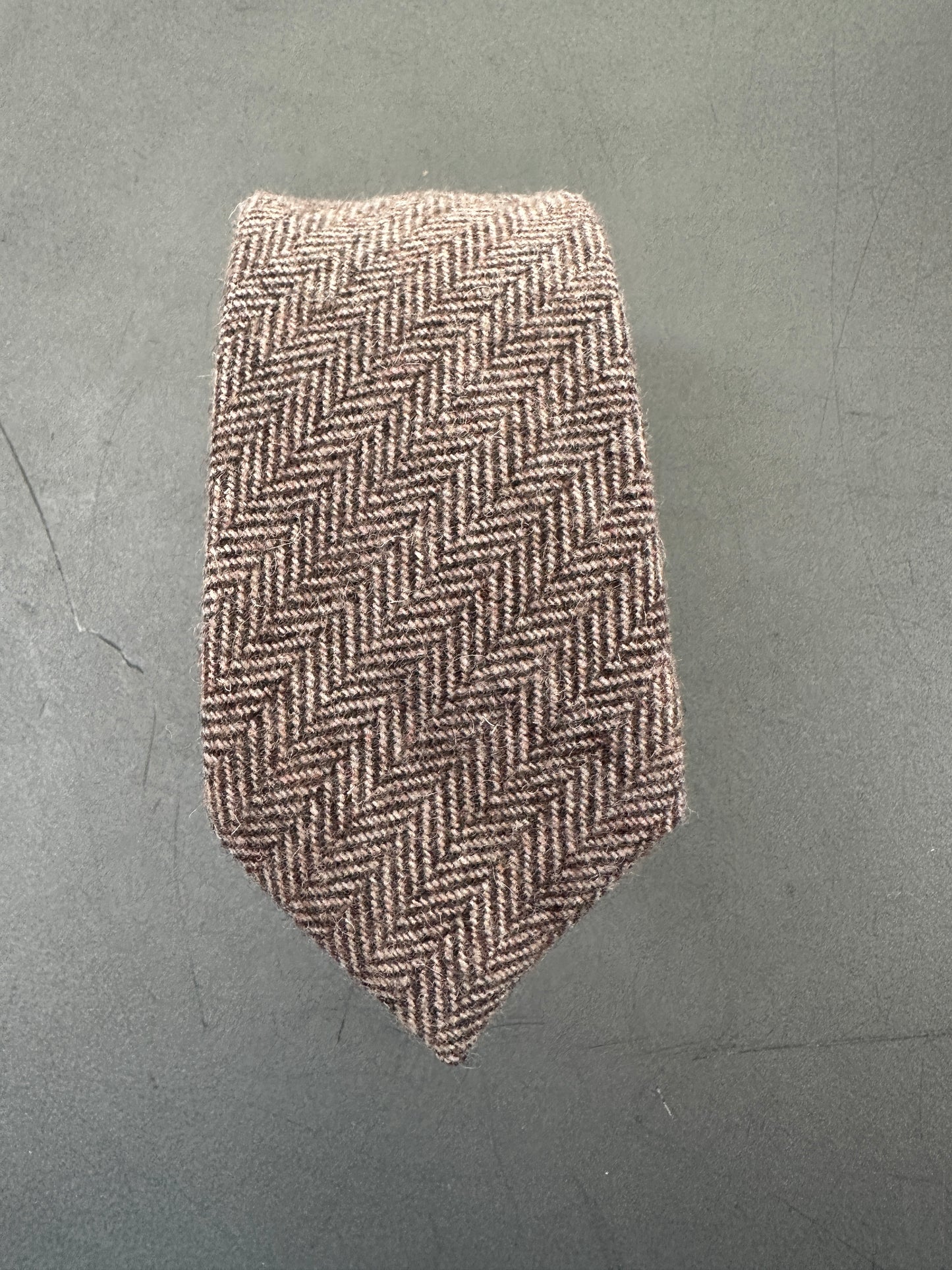 The Mangrove tie, featuring a classic brown herringbone pattern, pre-tied and ready to wear.