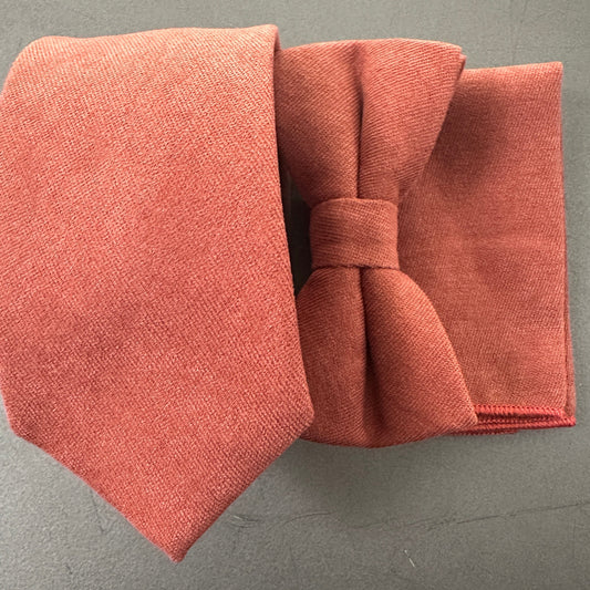 A terracotta and rust tie bow tie and pocket square set for men and grooms, groomsmen and wedding guest attire.