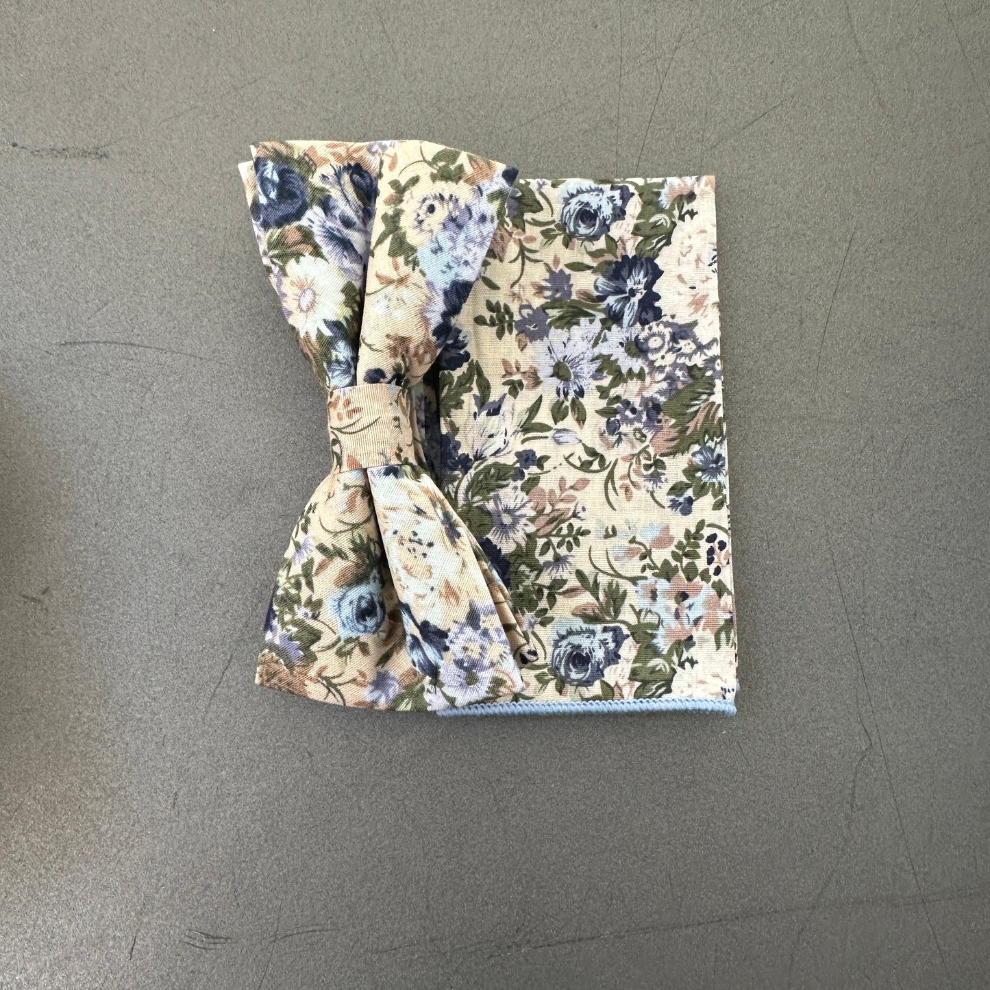 A Blue floral wedding bow tie and pocket square set for men in cotton floral fabric.