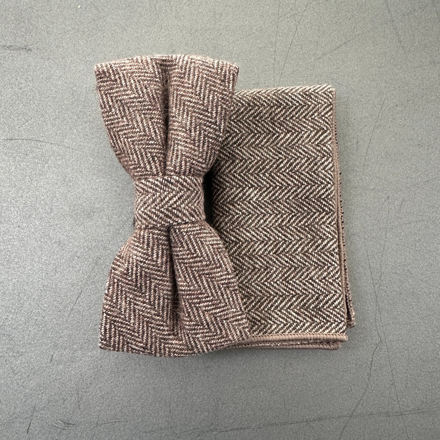 The Mangrove bow tie and pocket square, featuring a classic brown herringbone pattern, pre-tied and ready to wear. EDC Hanks.