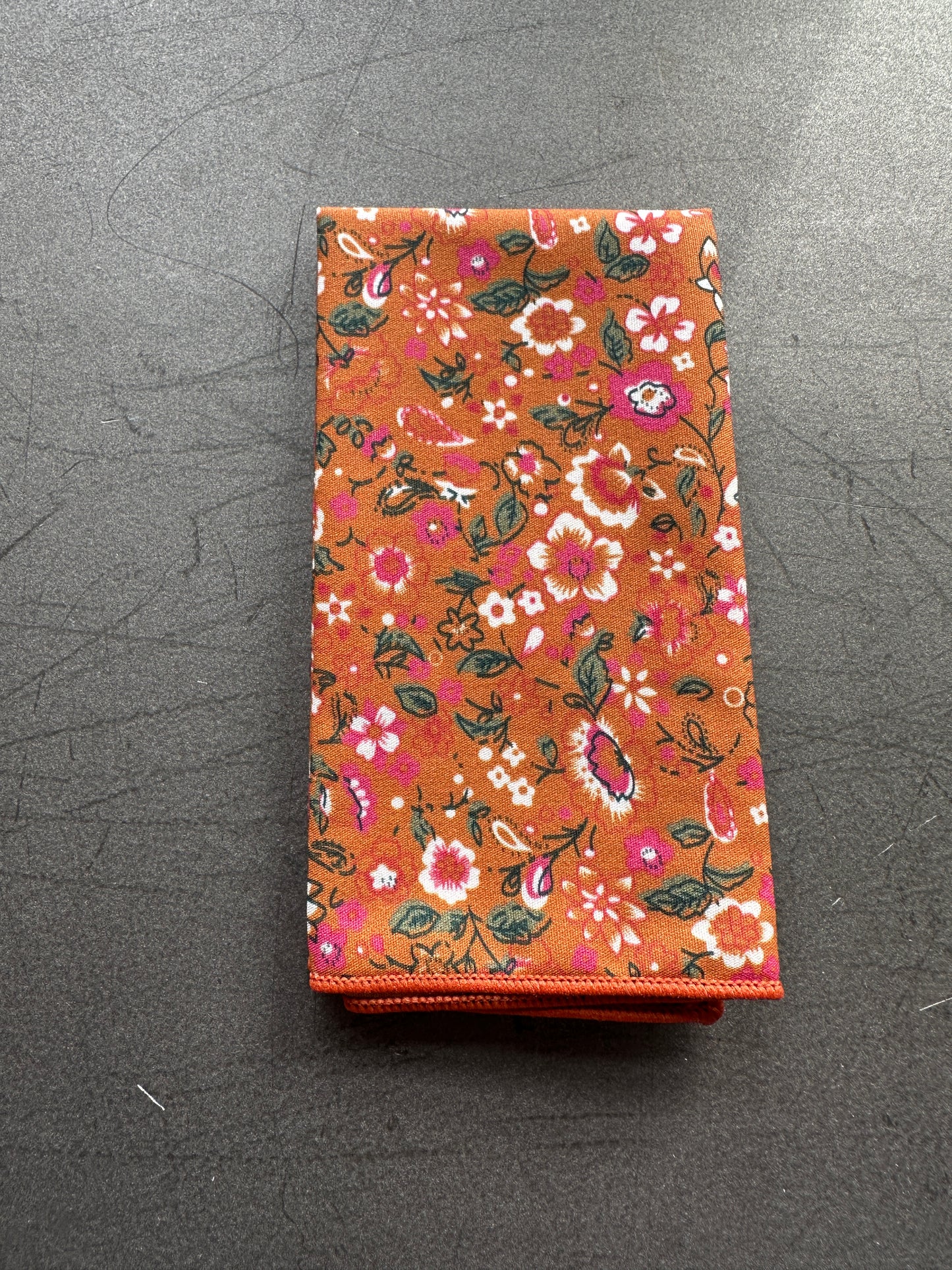 An image of a burnt orange and pink floral pocket square for weddings.