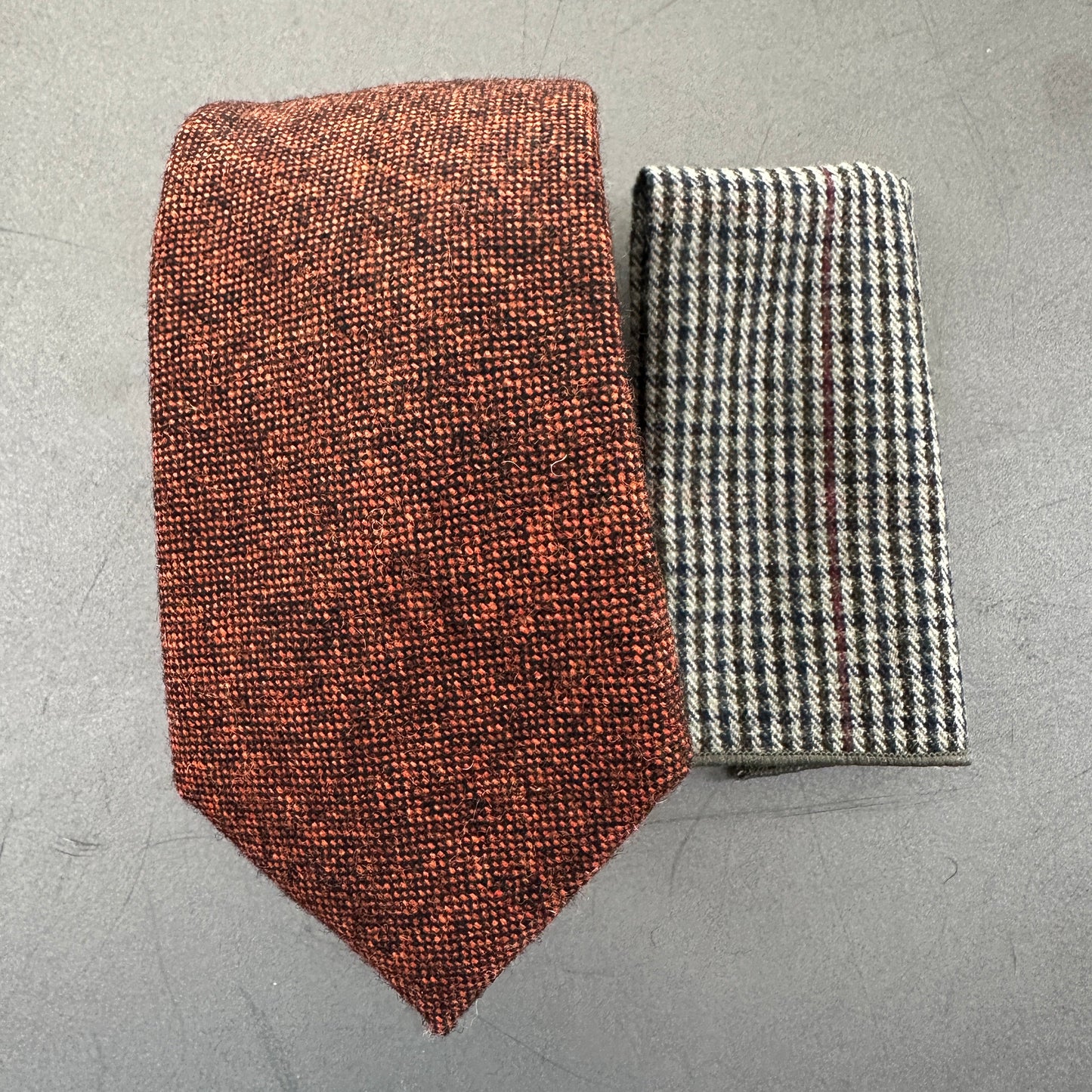 A burnt orange mens wool tie and check pocket square for weddings and mens gifts.