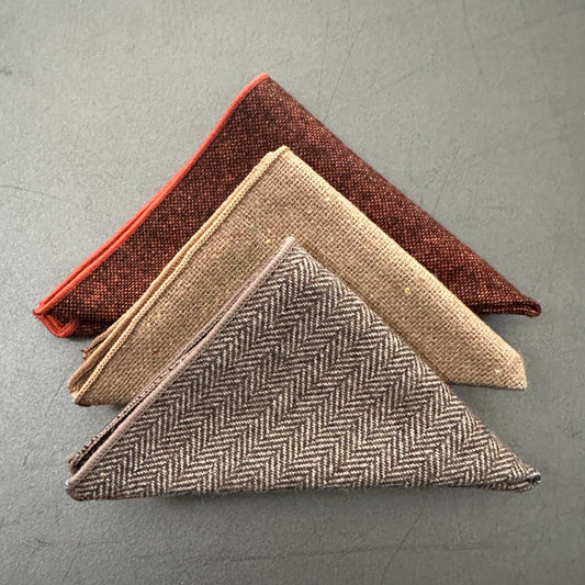 A set of three pocket squares for men in orange and brown wool.