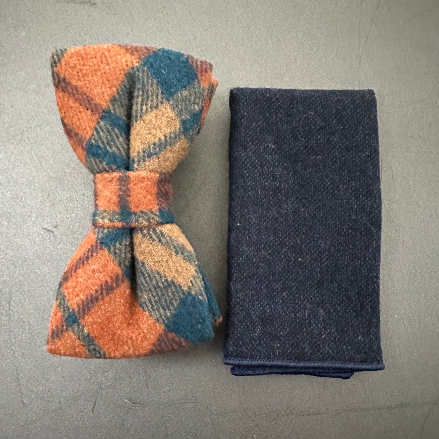 Men's burnt orange wool bow tie and navy pocket square for grooms and groomsmen.