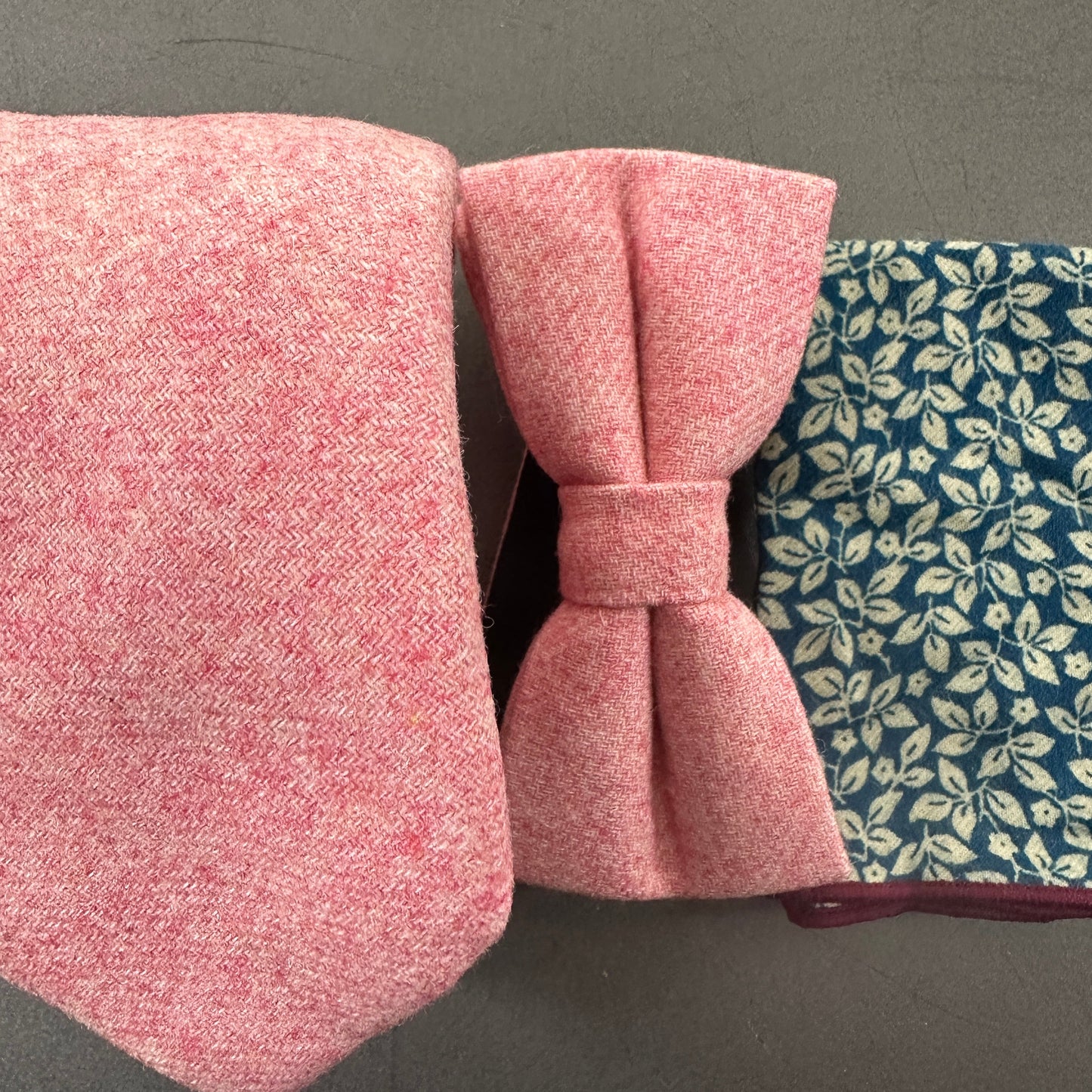 A blush pink mens tie and bow tie matched with a blue floral pocket square for wedding ties.