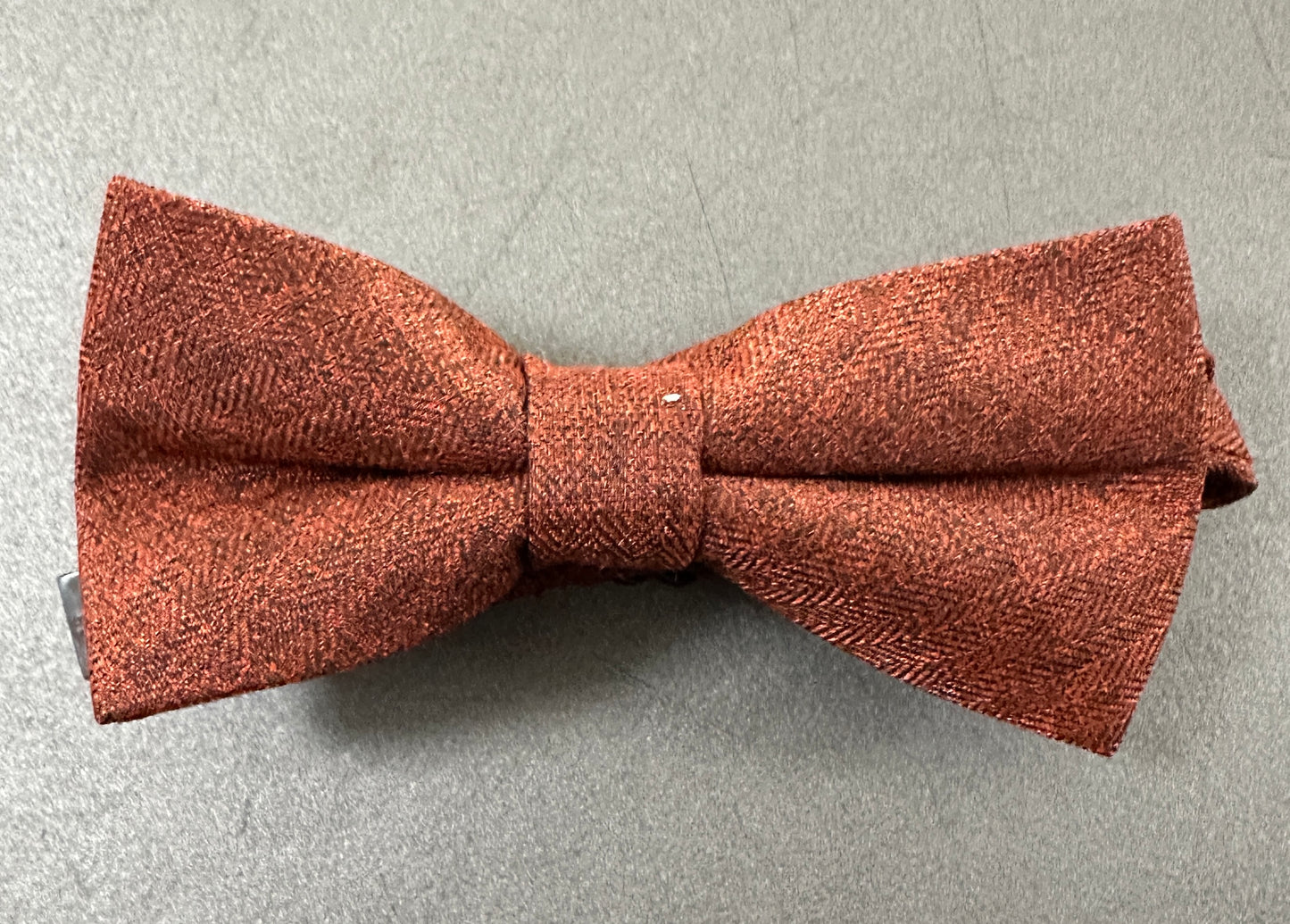 A childs burnt orange bow tie.
