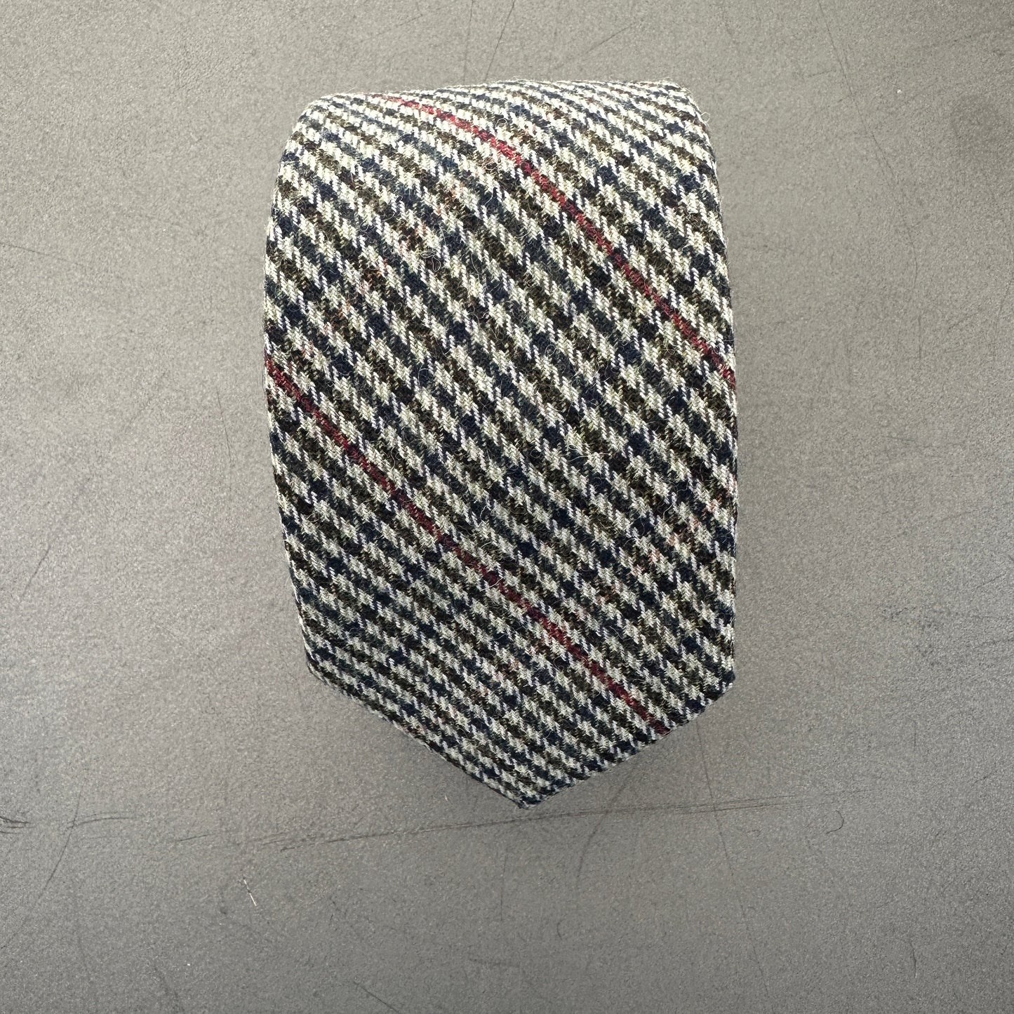 A grey, blue and red checked mens tie for gifts.