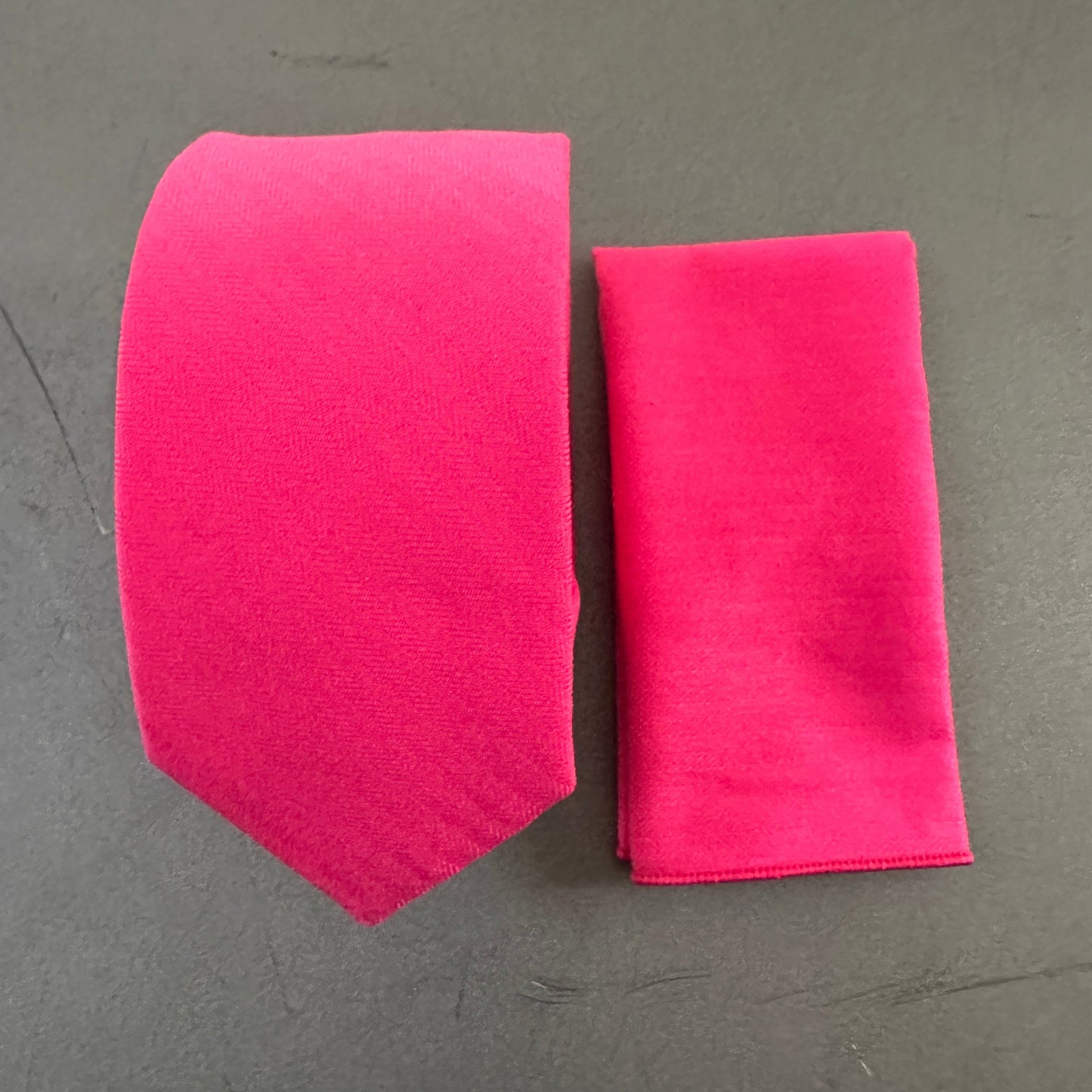 A hot pink tie and pocket square for men ideal for shocking pink wedding ties.
