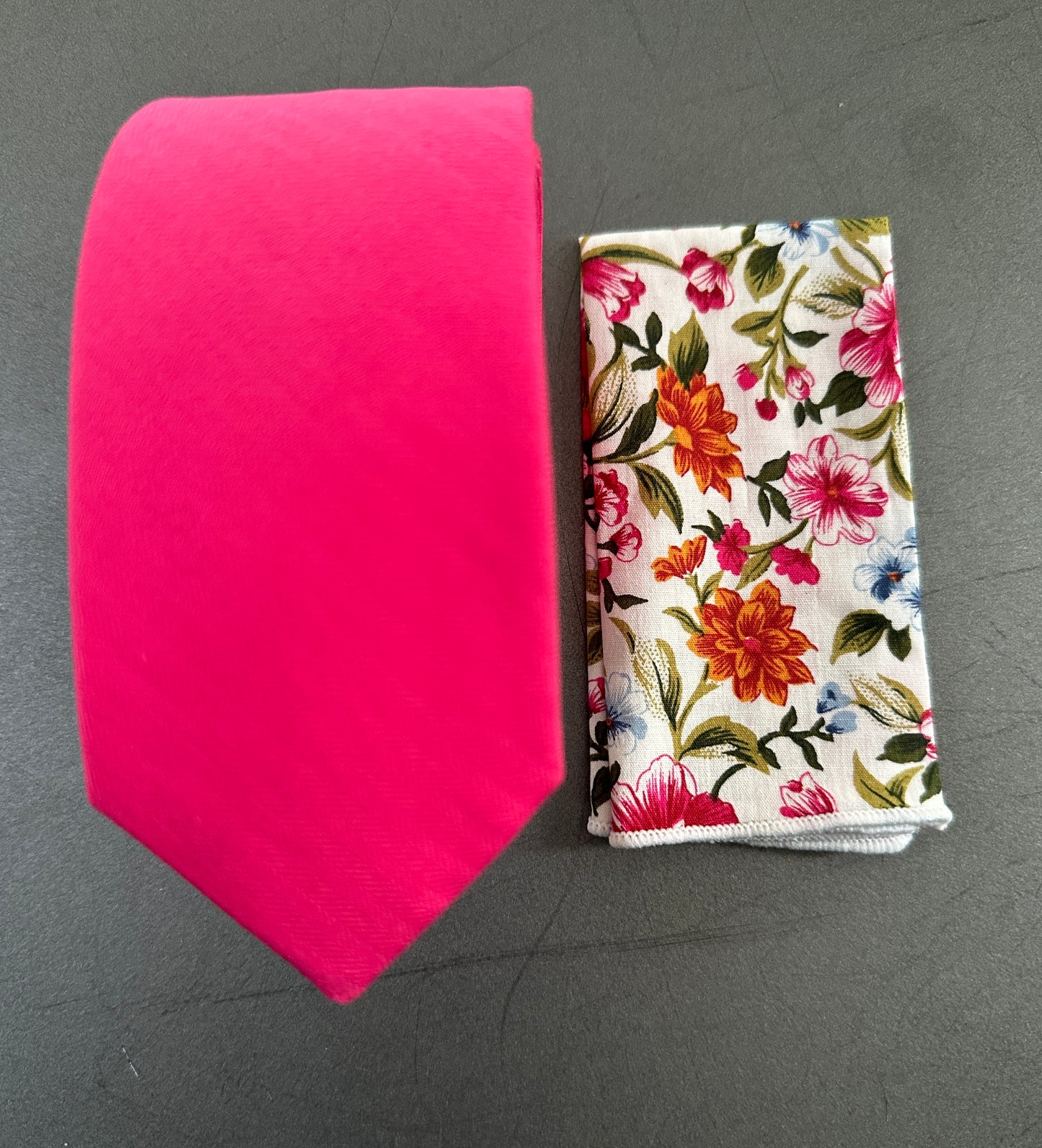 A photo of a hot pink tie and pocket square for men ideal for shocking pink wedding ties.