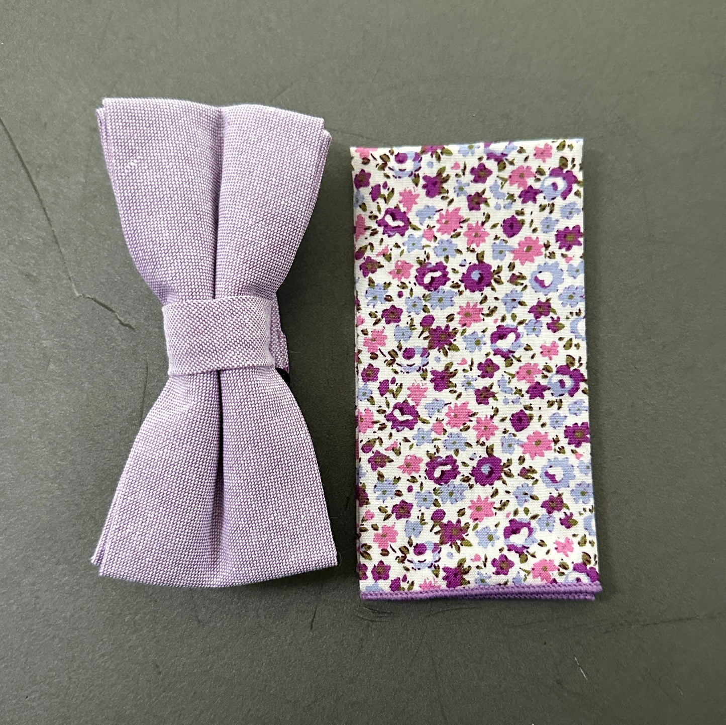 A purple floral mens bow tie and lilac pocket square set for weddings.