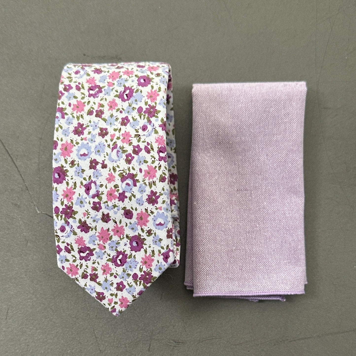 A purple floral mens tie and lilac pocket square set for weddings.