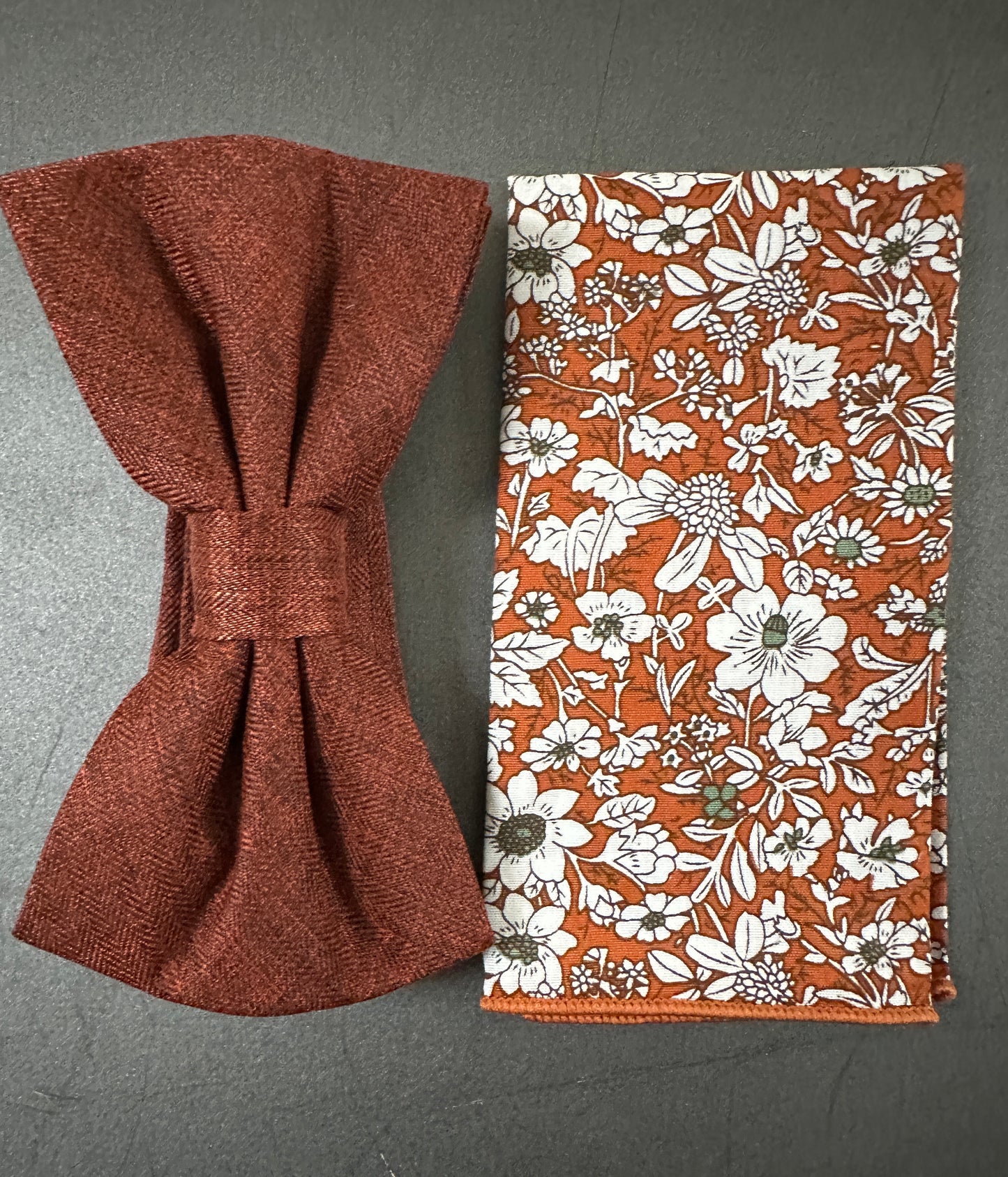 A burnt orange mens bow tie and pocket square for men.
