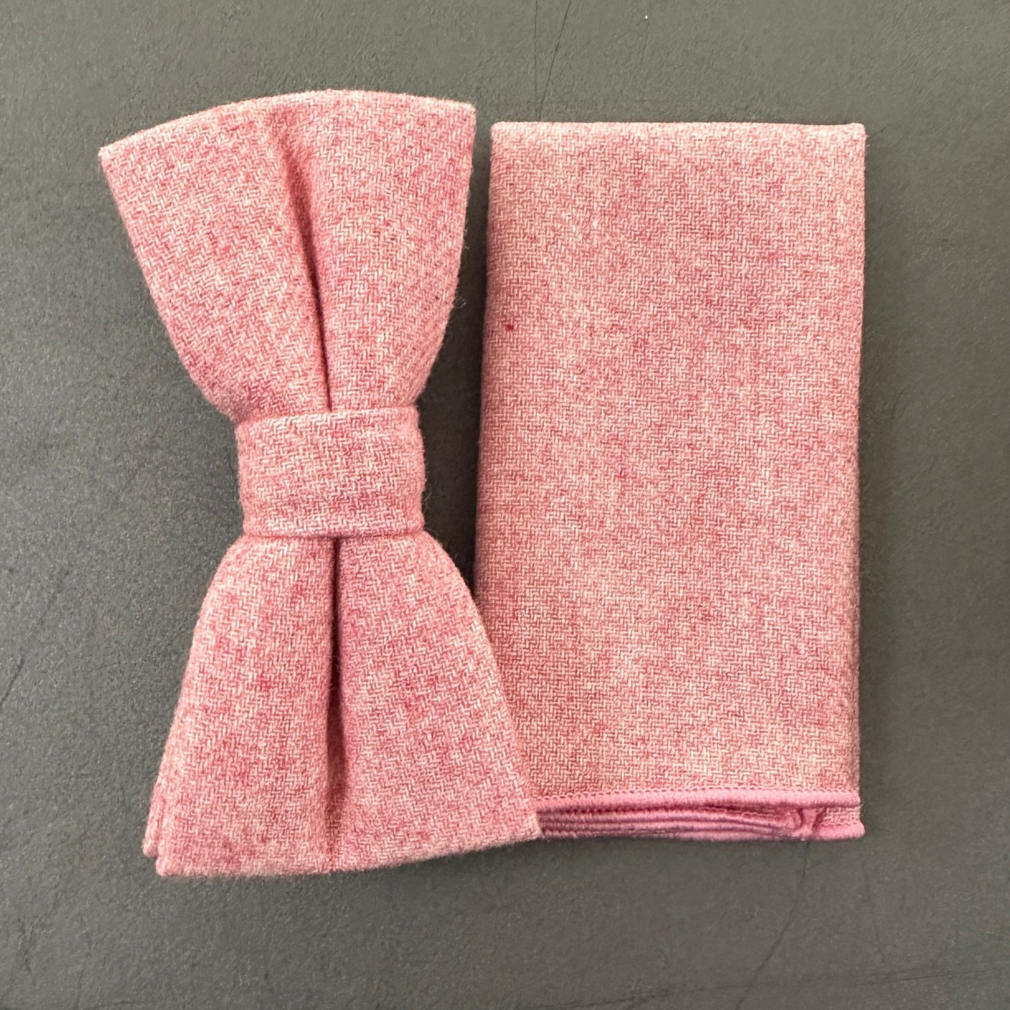 A pink bow tie and pocket square set in blush pink wool for grooms and groomsmen.