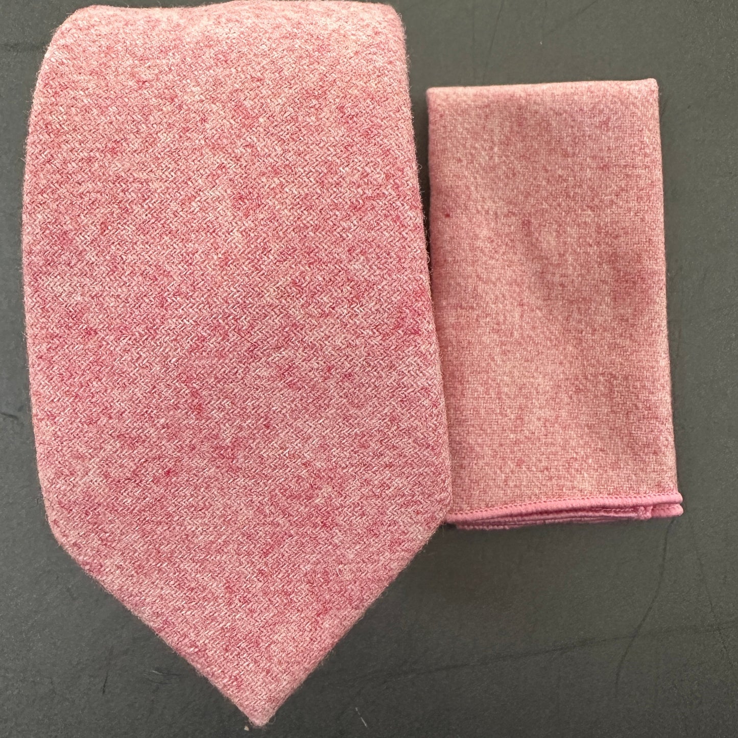 A blush pink wool tie set for wedding. Te tie comes with a matching pocket square and we also have matching bow ties available.