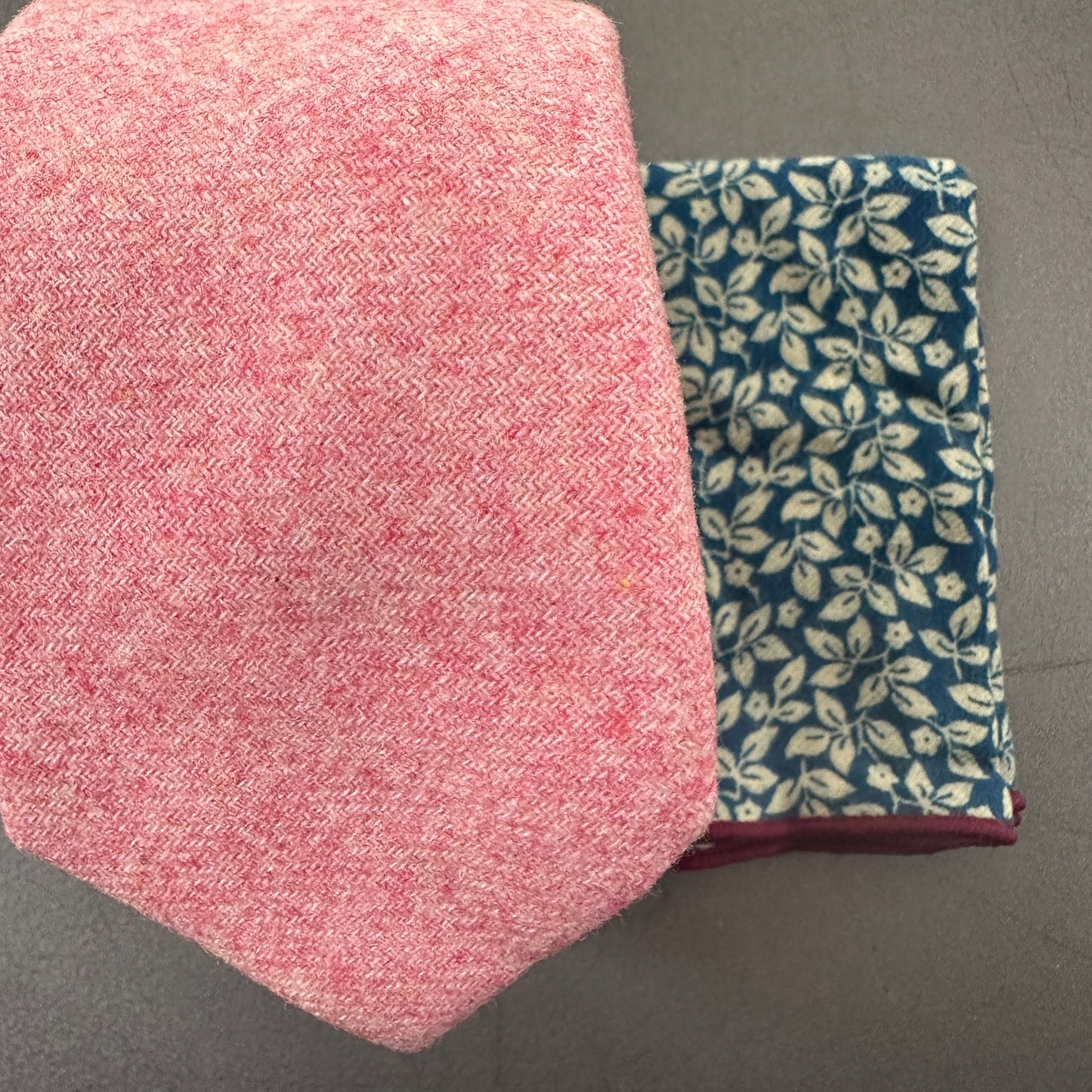 A p ink wool tie matched with a blue pocket square ideal for baby blue and blush weddings.
