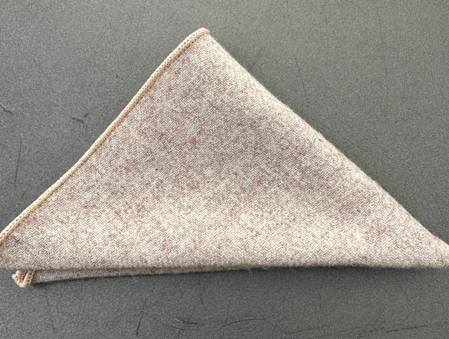 A cream pocket square in a set of three unisex pocket squares in red, cream and pink herringbone wool. Ideal as EDC hanks and as gifts. The set comes with free gift wrap.