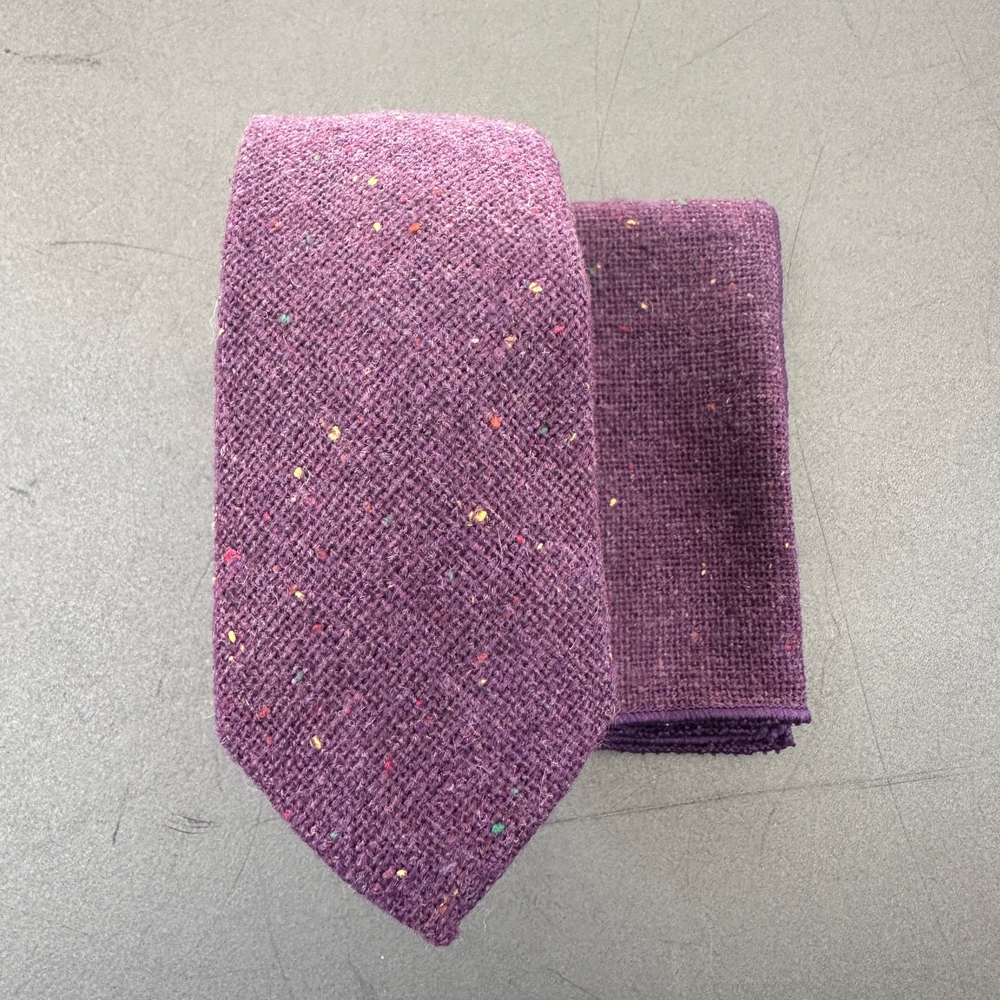 Men's purple wedding tie, bow tie, and pocket square set.