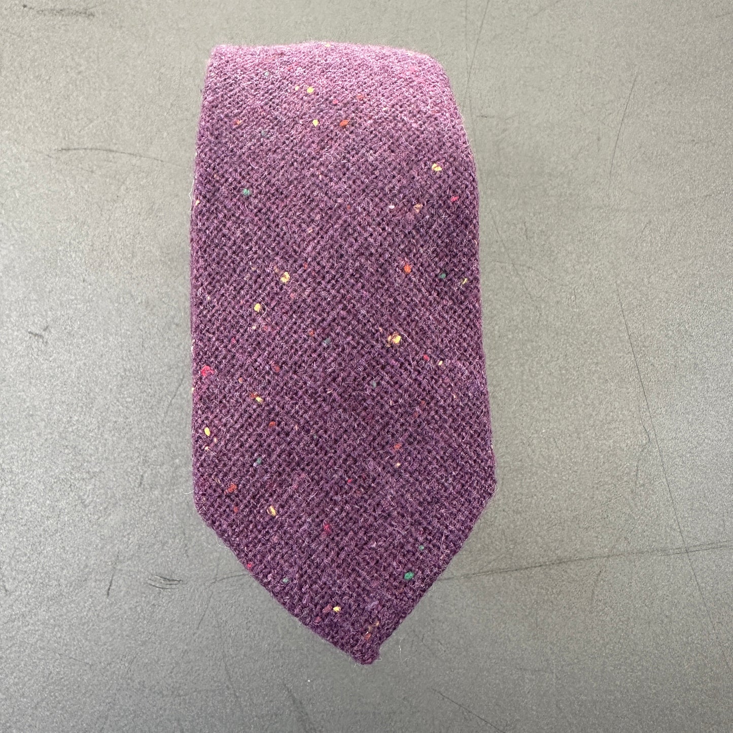 Elegant purple tie, bow tie, and pocket square for groomsmen attire.