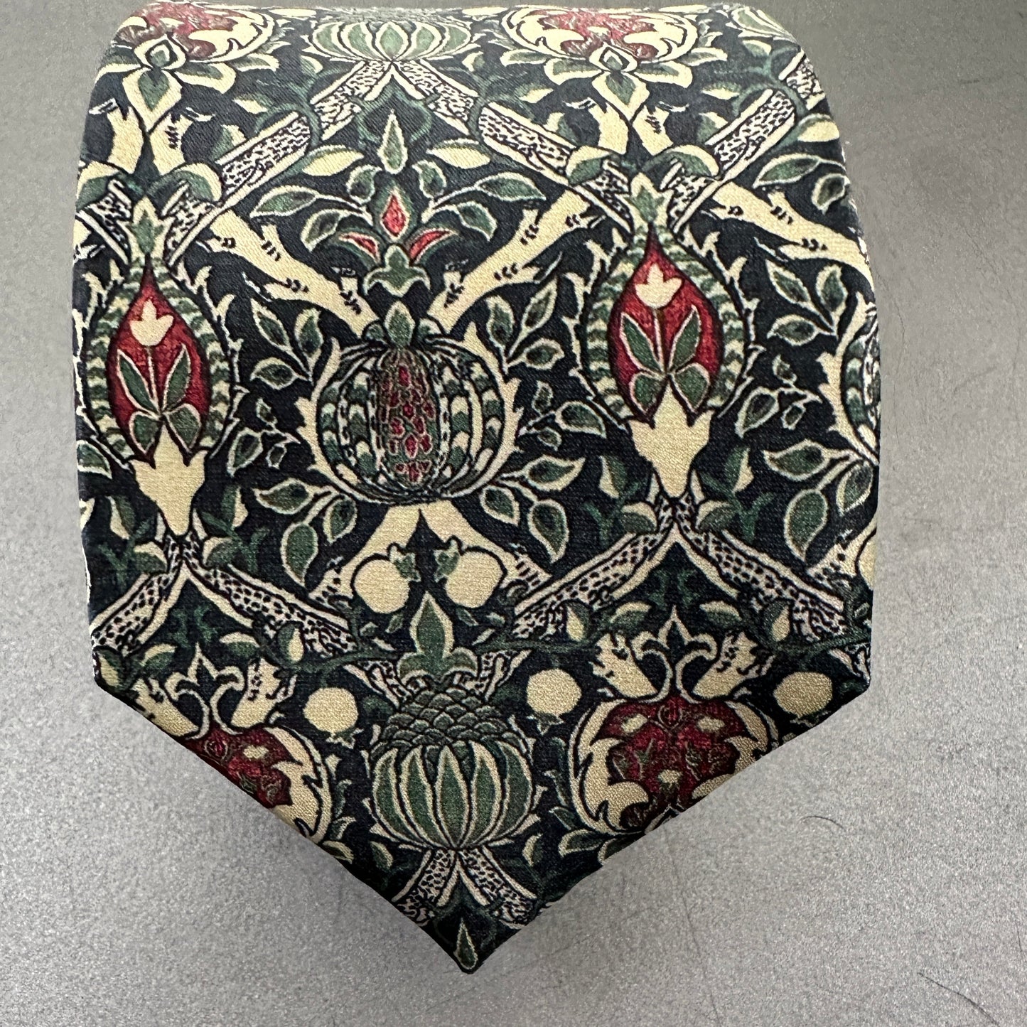 Men's green and red tie in unique art and crafts print.