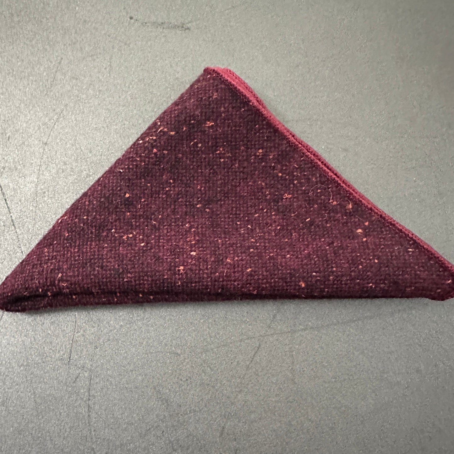 A red pocket square in a set of three unisex pocket squares in red, cream and pink herringbone wool. Ideal as EDC hanks and as gifts. The set comes with free gift wrap.