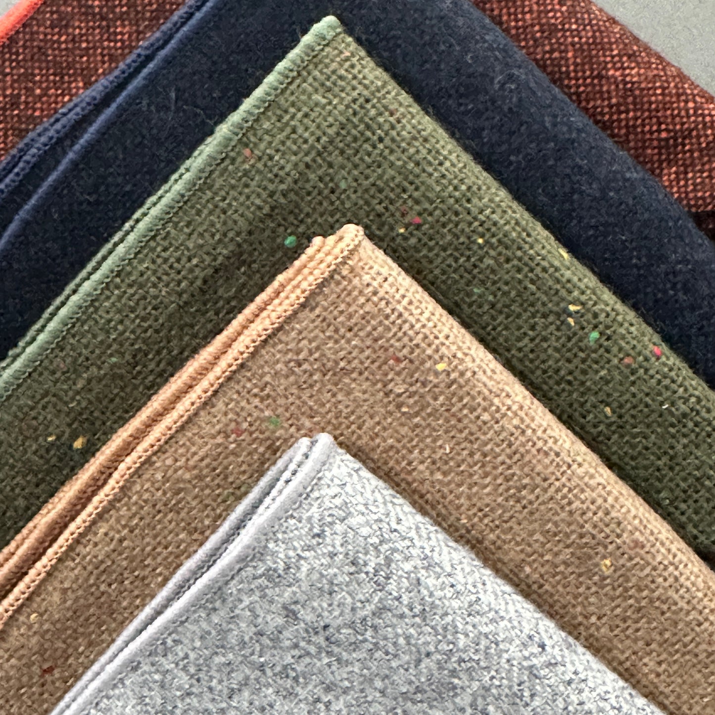 A set of five wool pocket squares for men in burnt orange, navy, brown and grey. Ideal EDC hanks and mens gifts and groomsmen. gifts.