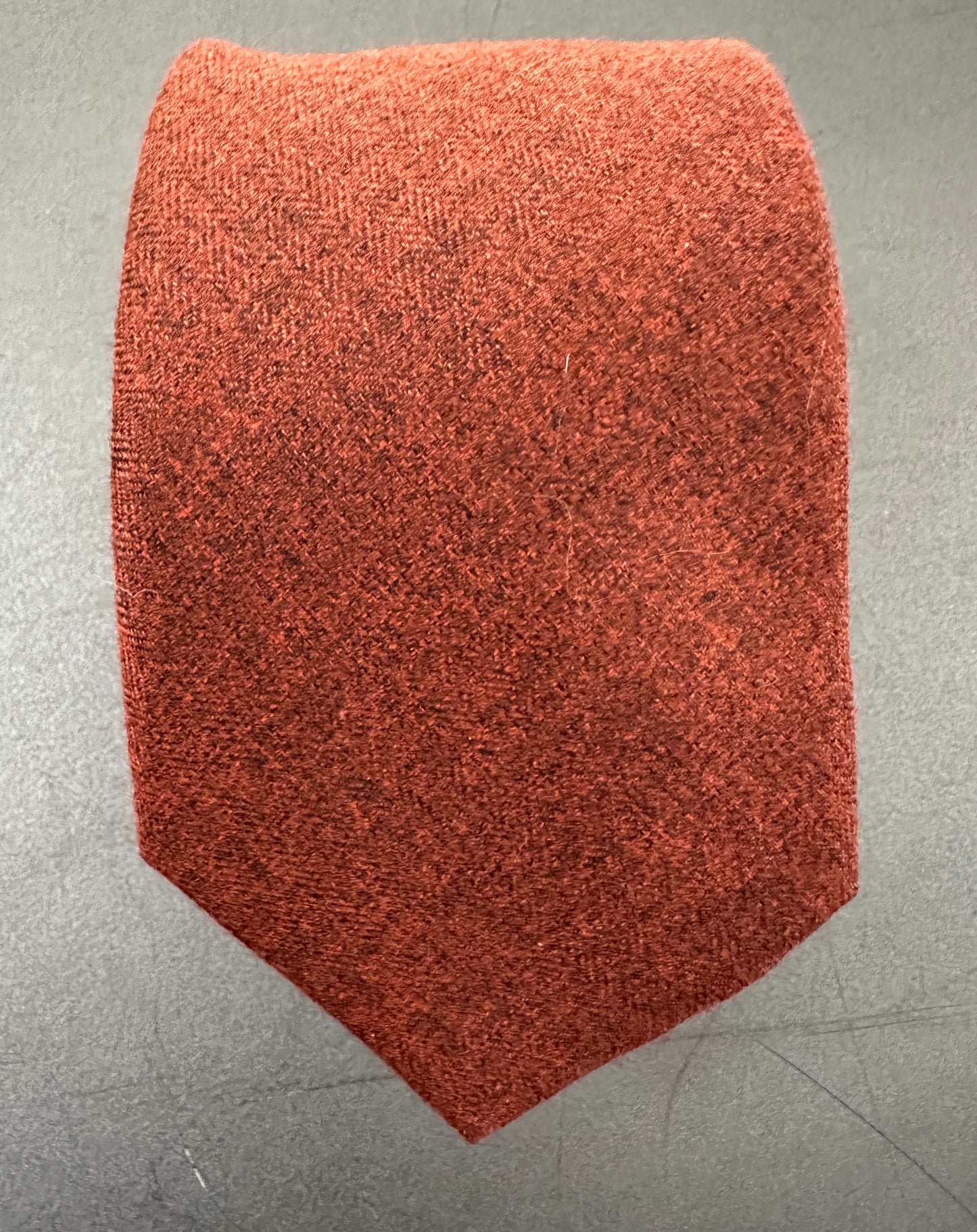 A burnt orange tie for men in three different widths: skinny, classic and wide.