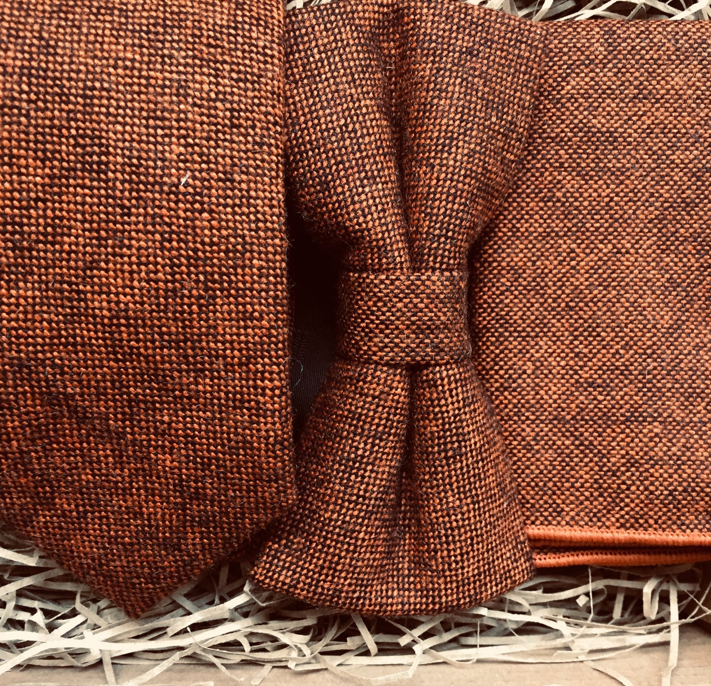 A burnt orange wool mens tie, bow tie and pocket square in a flecked wool fabric. The set makes an ideal mens gift and comes with free shipping and gift wrapping. Handmade by Daisy and Oak Studio