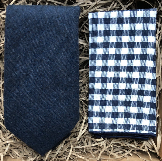 A navy blue wool men's necktie gift wrapped and perfect for men's Christmas gifts and as a navy wedding tie It is paired with a checked men's handkerchief.