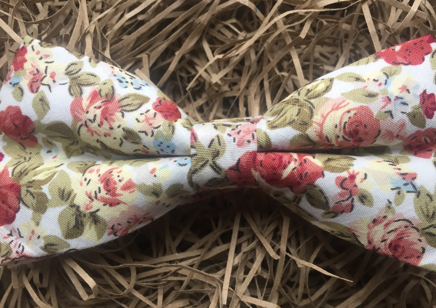 A pink, floral men's bow tie. This dickie bow is ideal as a wedding bow tie and for formal wear. The bow tie is handmade by Daisy and Oak Studio, UK