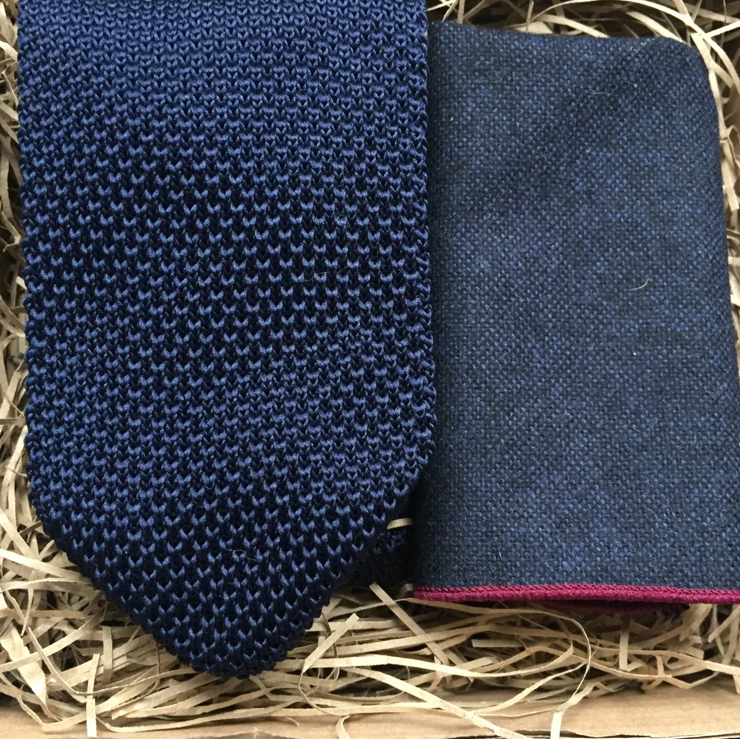 A men's navy blue knitted tie and navy wool pocket square set, handmade at Daisy and Oak Studio, UK. Includes free gift wrap – perfect for men's gifts and weddings.