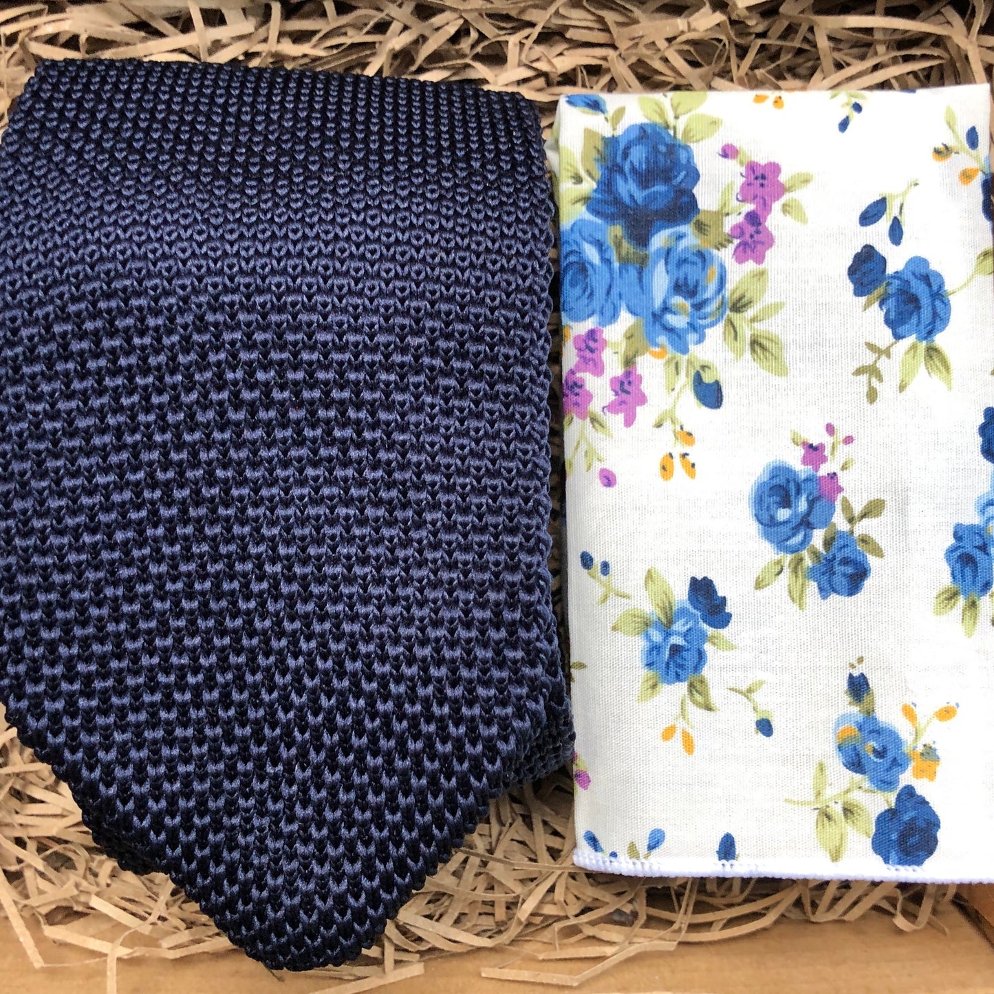 A man's tie in a navy knitted fabric and a white cotton pocket square handkerchief. The set is ideal as a men's gift and comes gift wrapped by Daisy and Oak Studio.