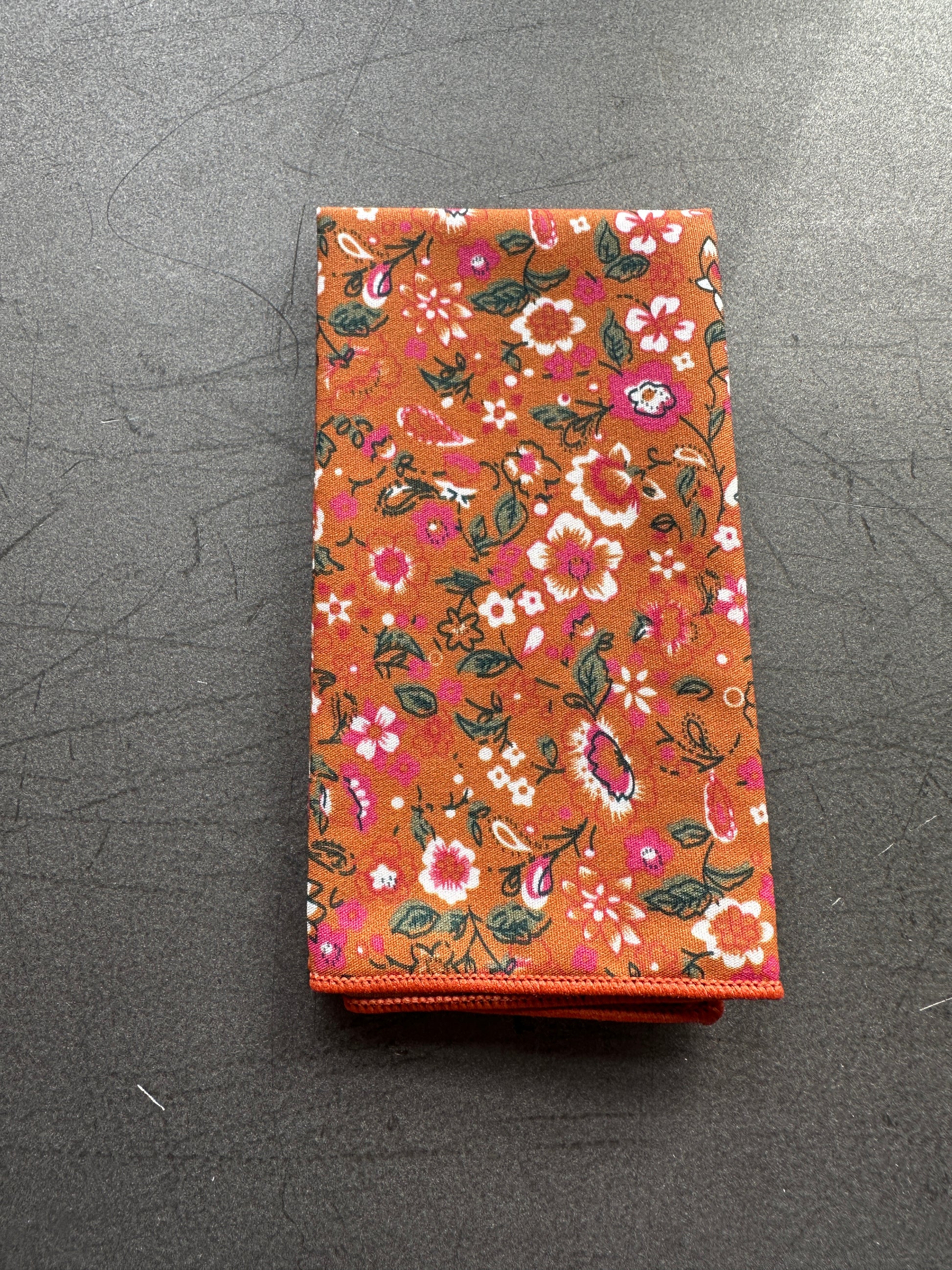 An image of a burnt orange and pink floral pocket square for weddings.