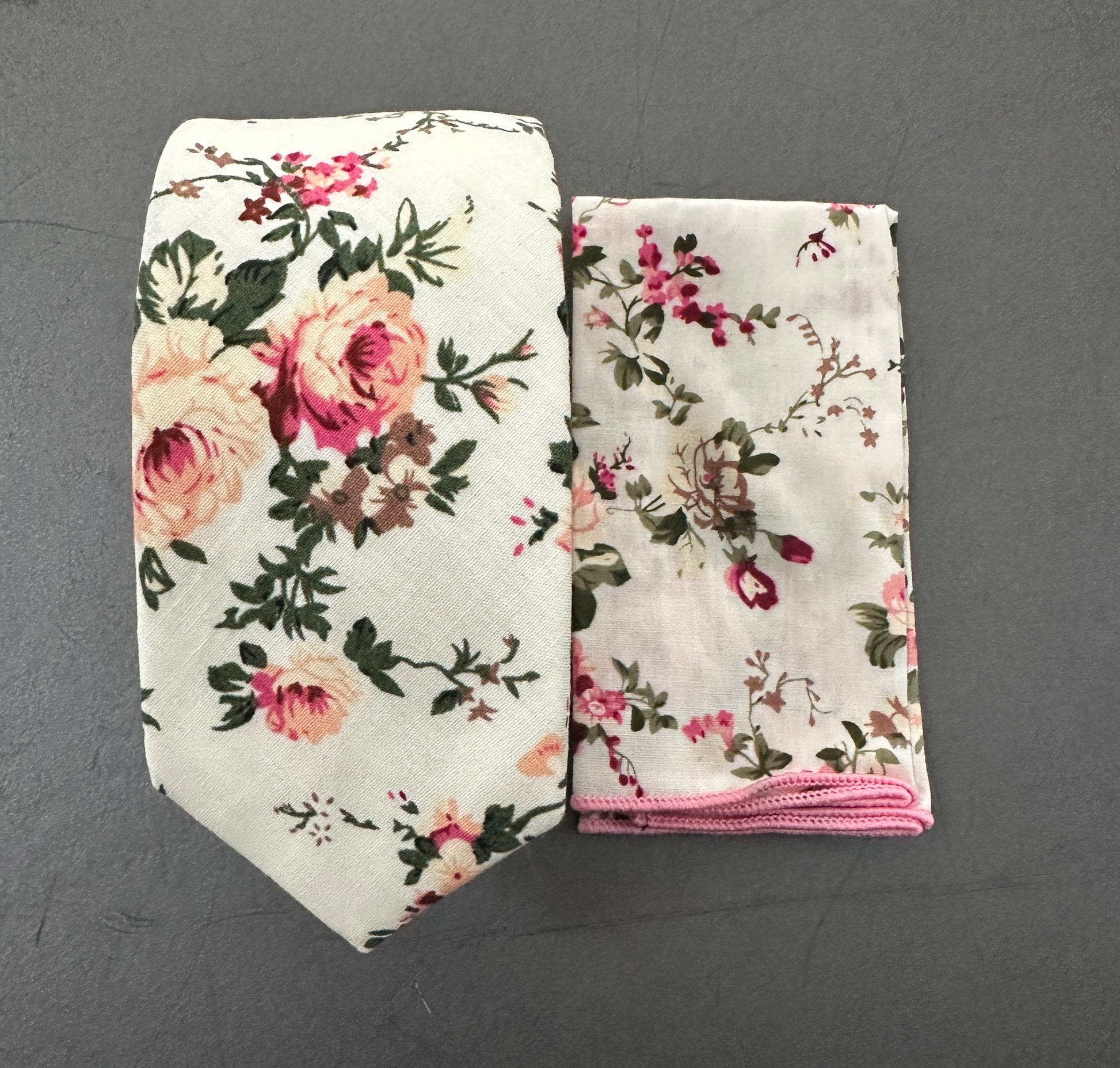 A blush pink rose. tie and pocket square set for weddings. The set is made in cotton and is on a cream background.