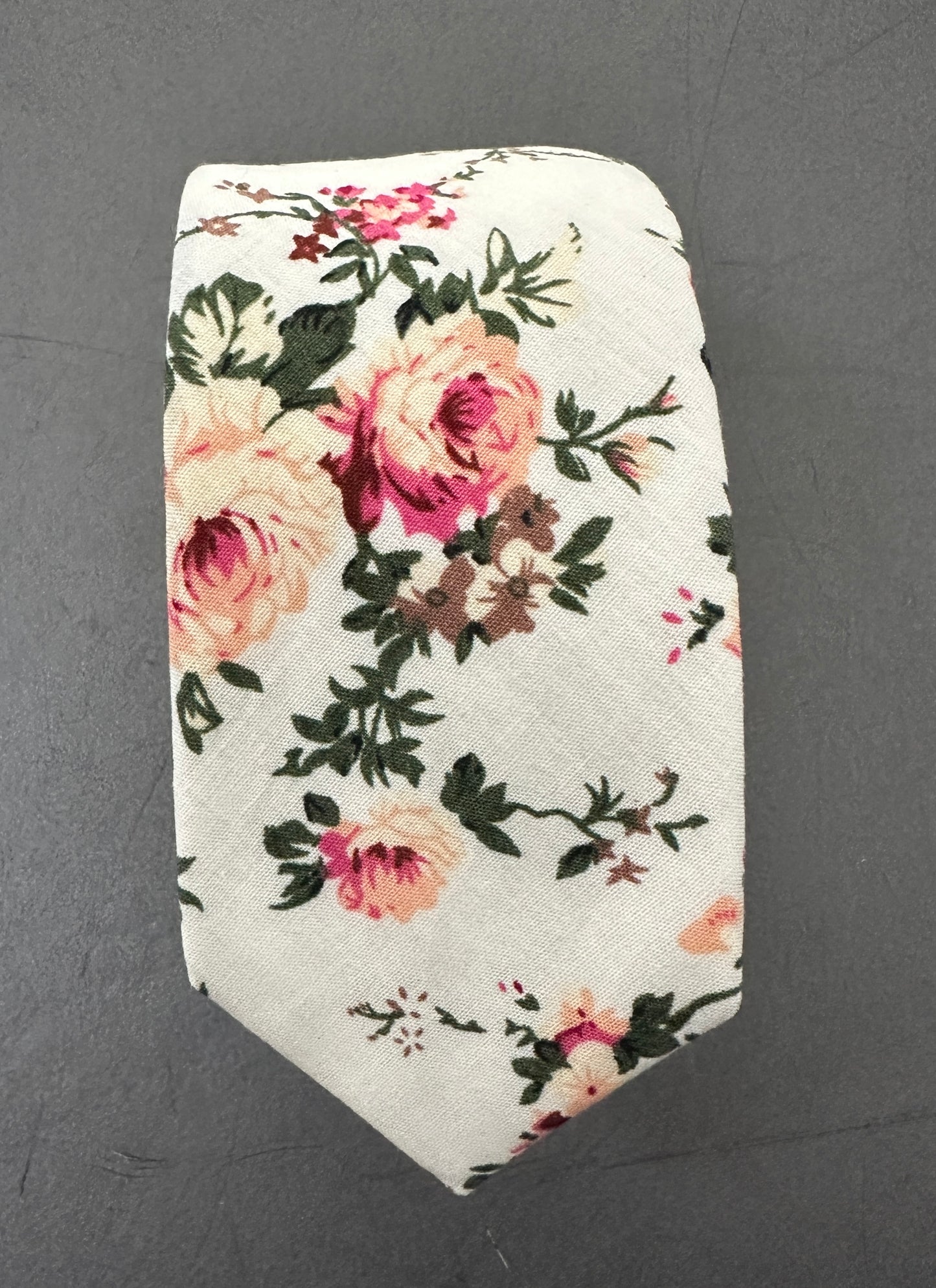 A blush pink rose ttie for weddings. The set is made in cotton and is on a cream background.