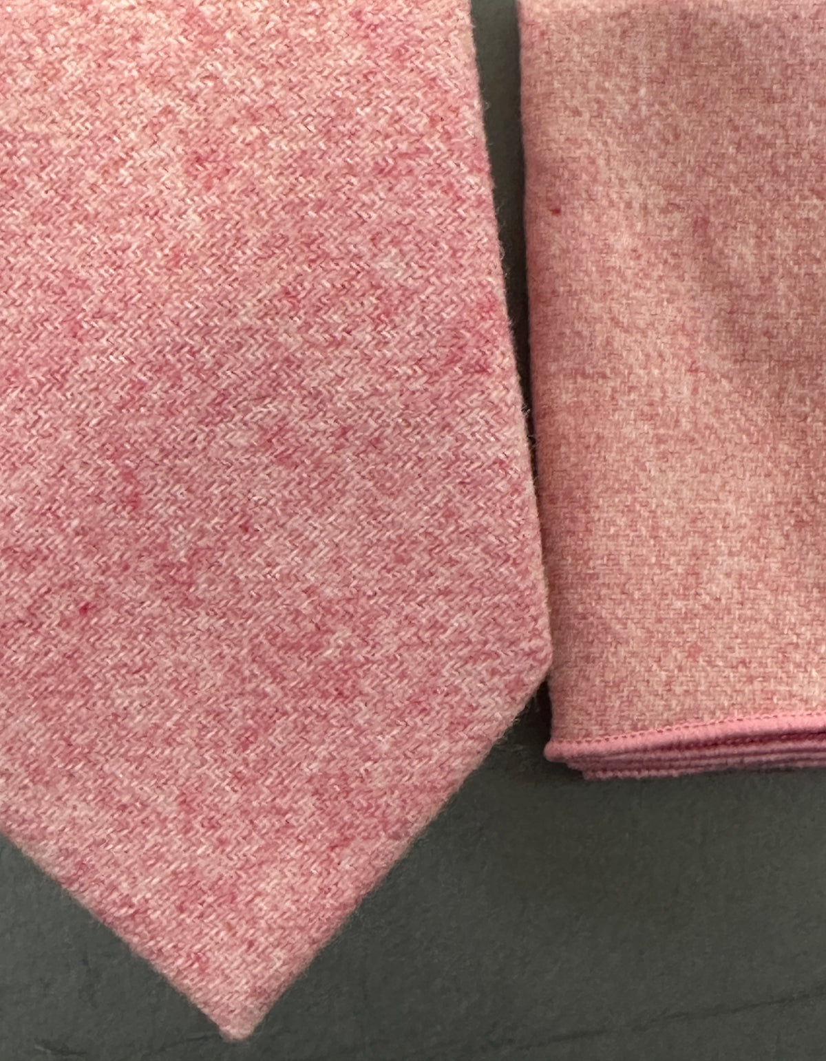 A pink tie and pocket square set in blush pink wool for grooms and groomsmen. Ideal for weddings.
