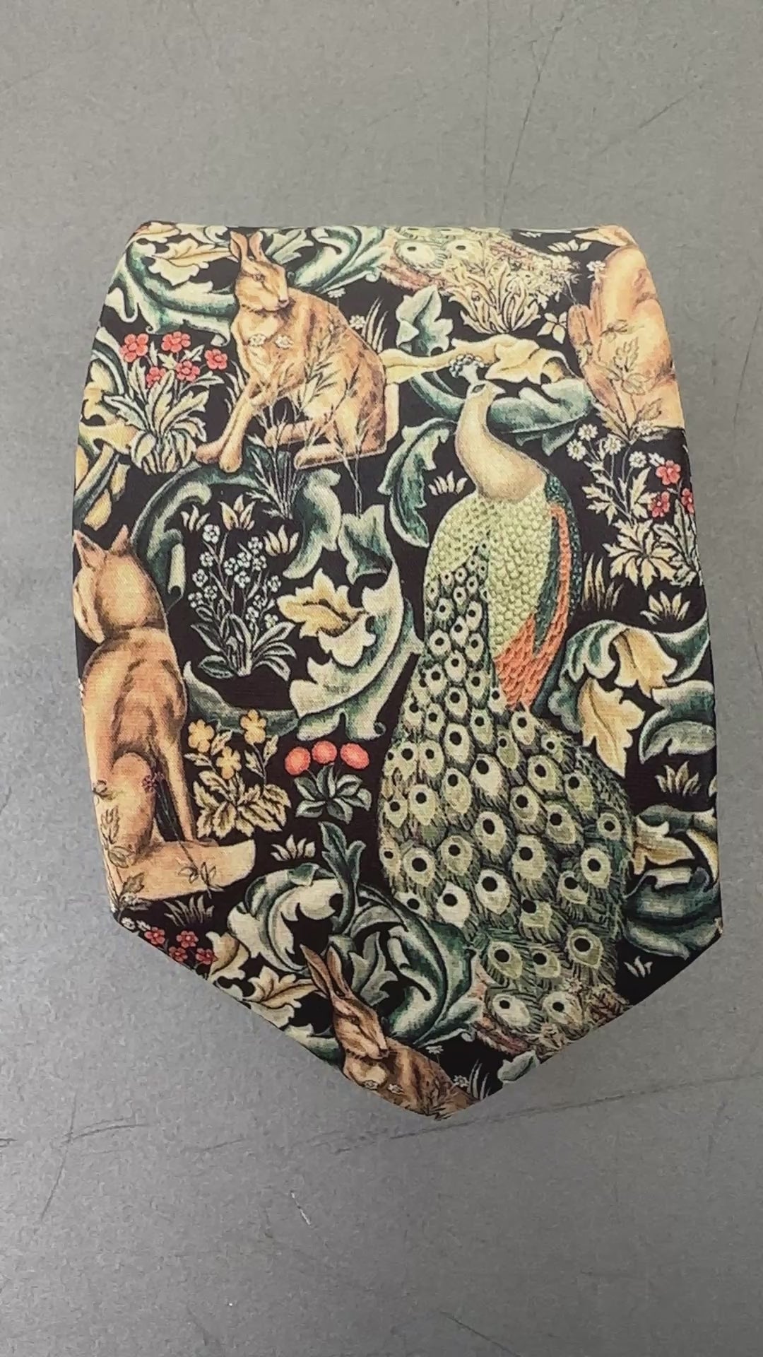 A video of a peacock print tie with hares and perfect as a hunting tie or men's gifts.