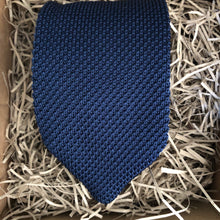 Load image into Gallery viewer, A navy knitted necktie suitable for all occasions. The necktie is wrapped in a gift box with a gift tag so is suitable as a men&#39;s Christmas gift. Handmade by Daisy and Oak Studio.