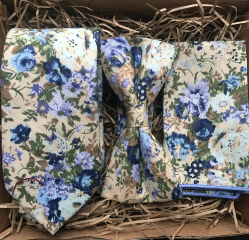 A men's bue floral tie, bow tie and pocket square set ideal for weddings and as men gifts. The set comes with free gift wrapping and is made at Daisy and Oak Studios, UK