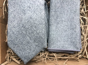 A grey wool tie and pocket square set. The set is gift wrapped and so is an ideal christmas gift for men, groomsman gift or secret santa gift from Daisy and Oak studio