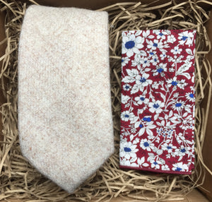 A cream wool men's tie and red floral pocket square handkerchief. Ideal as men's wedding attire for men, men's gifts and groomsmen gifts. The set comes gift wrapped and is perfect for a men's Christmas present. By Daisy and Oak Studio.