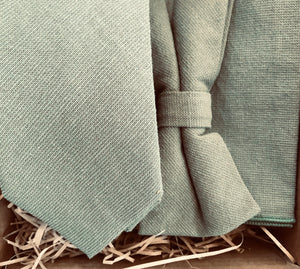 A sage green men's tie, bow tie and pocket square made in cotton and ideal as a wedding tie. The ties are handmade by Daisy and Oak Studio and come with free shipping and gift wrap so making an ideal groomsmen gift or mens gift.