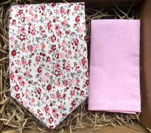 A pink floral necktie in cotton and a pink pocket square. Perfect for weddings and as a grooms man gift.