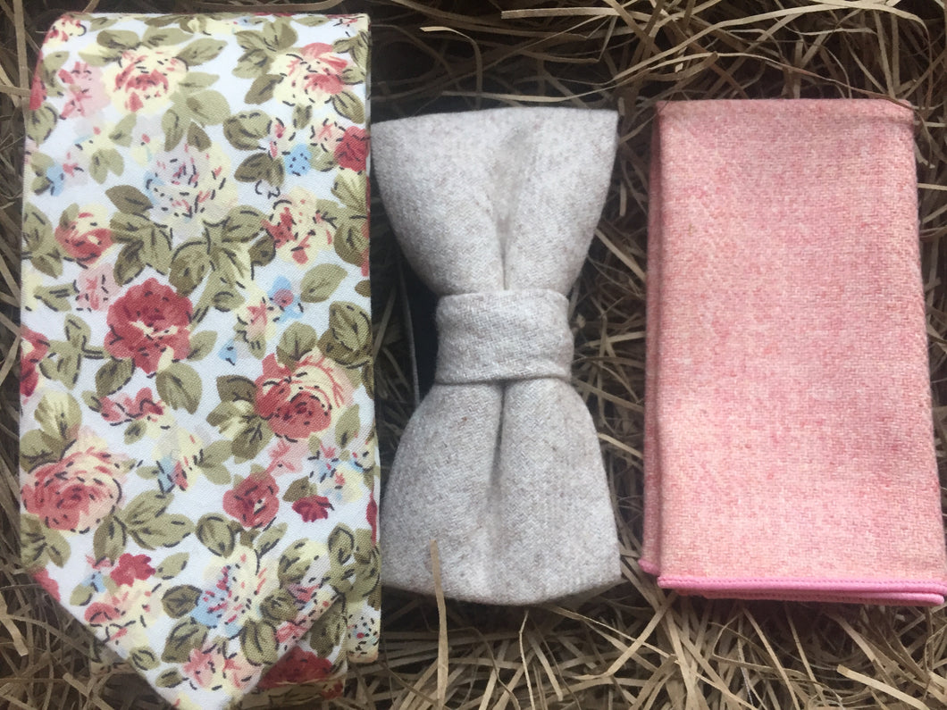A pink floral men's tie, cream wool bow tie and  pink wool pocket square. The tie set comes with free gift wrapping and is handmade in the Daisy and Oak Studio, UK