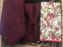 Load image into Gallery viewer, A deep red wool tie, bow tie and pocket square set. The tie is made in wool and is flecked with yellow, red, and blue flecks. The pocket square is a pink floraland handmade at Daisy and Oak Studio, UK