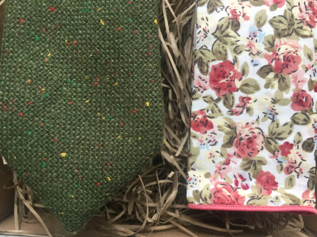 A green flecked wool tie with yellow, red and green flecks. The pocket square is in a pink floral cotton. The tie set comes gift wrapped and makes the ideal men's gift. Handmade by Daisy and Oak Studio.