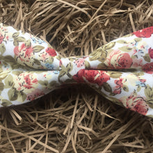 Load image into Gallery viewer, A pink, floral men&#39;s bow tie. This dickie bow is  ideal as a wedding bow tie and for formal wear. The bow tie is handmade by Daisy and Oak Studio, UK