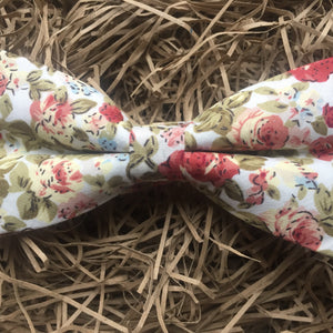 A pink, floral men's bow tie. This dickie bow is  ideal as a wedding bow tie and for formal wear. The bow tie is handmade by Daisy and Oak Studio, UK