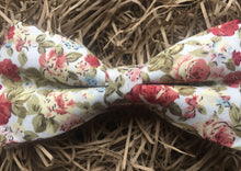 Load image into Gallery viewer, A pink, floral men&#39;s bow tie. This dickie bow is  ideal as a wedding bow tie and for formal wear. The bow tie is handmade by Daisy and Oak Studio, UK